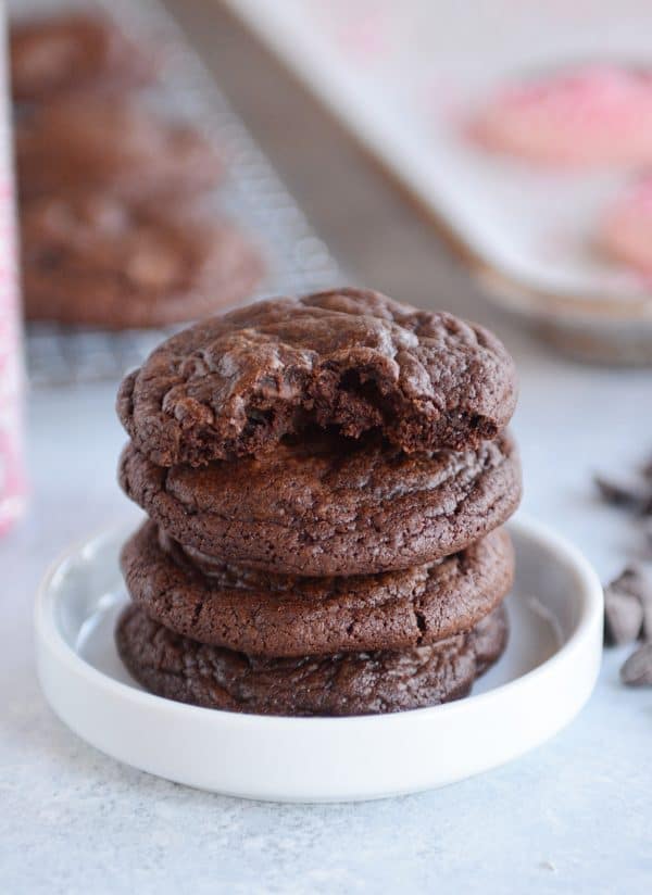 A stack of chocolate cookies on a small white plate. 