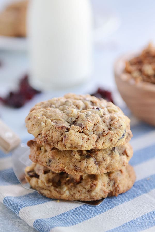A stack of granola chocolate chip cookies on a blue and white napkin.