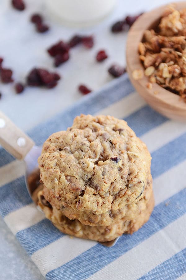 A metal spatula with stacked chocolate chip granola cookies on top.