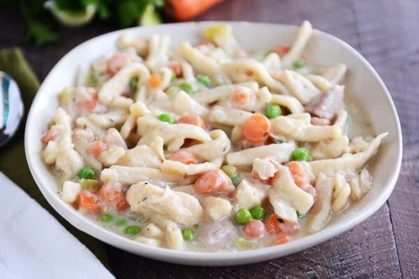 Top view of a bowl full of chicken noodle and vegetable stew.