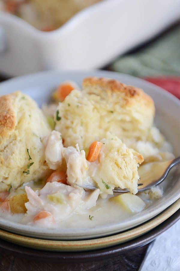 Biscuit-topped chicken pot pie in a white bowl.