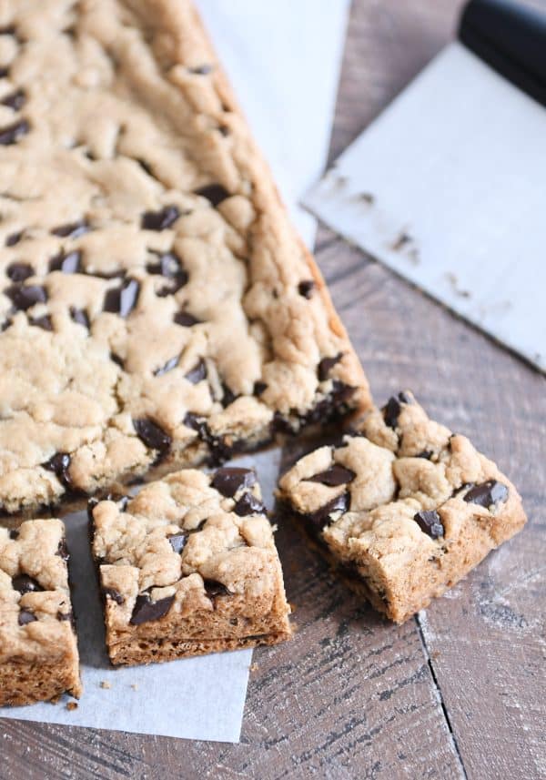 Slab of chocolate chip cookie bars cut into pieces.