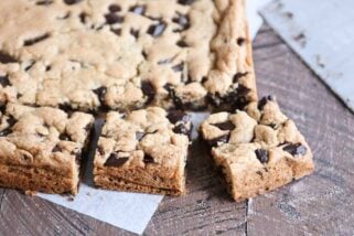 Slab of chocolate chip cookie bars cut into pieces.