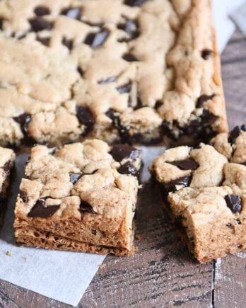 Slab of chocolate chip cookie bars cut into pieces.