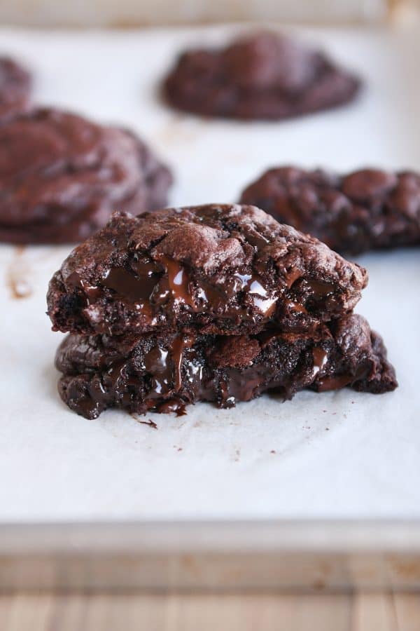 Double dark chocolate cookie broken and stacked on top of each other.