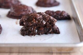 Double dark chocolate cookie broken and stacked on top of each other.