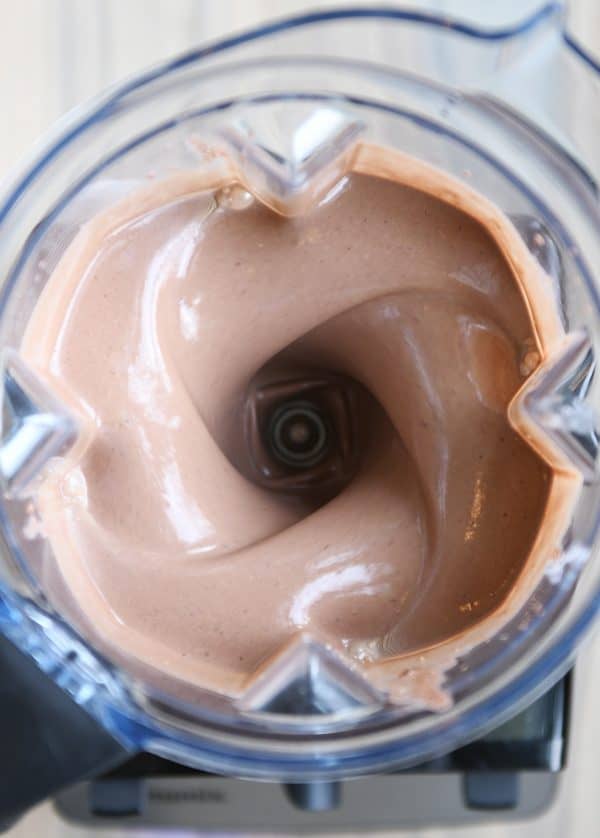 Blending chocolate protein smoothie.