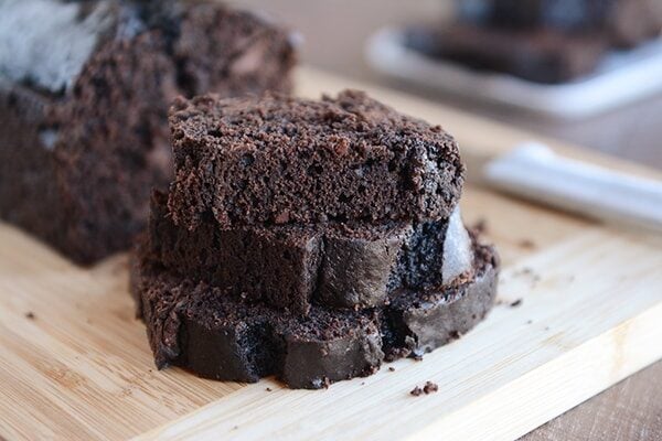 Thick slices of double chocolate quick bread cut off of the loaf of bread.