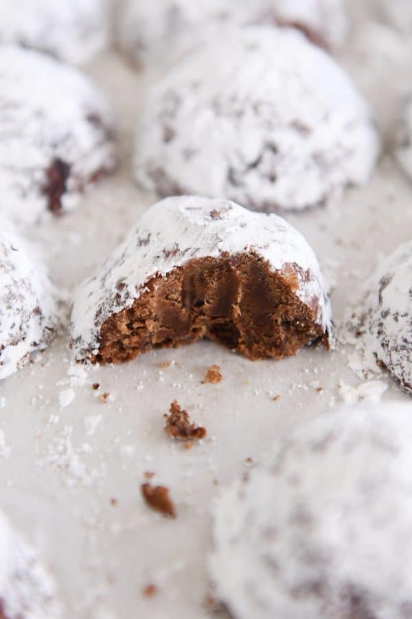 Chocolate truffle cookie on sheet pan broken in half.