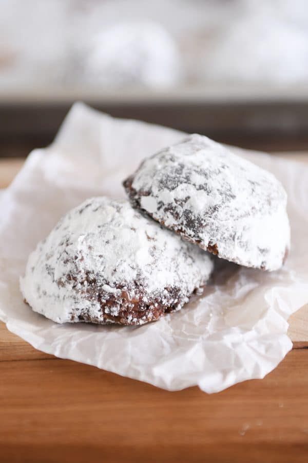 Two chocolate truffle cookies on a white napkin.