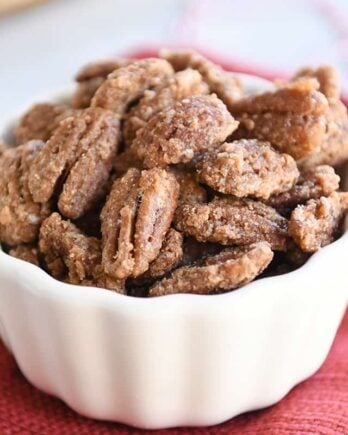 Easy cinnamon and sugar candied pecans in white bowl.