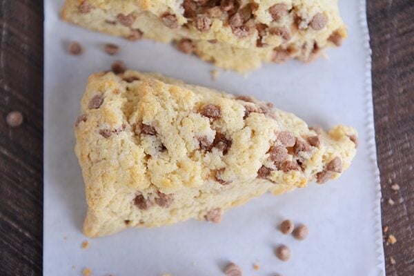 Top view of a chocolate chip scone on a piece of parchment.