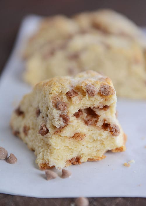 A chocolate chip cinnamon scone with a bite taken out.