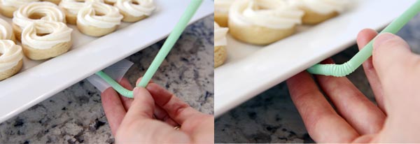 A green straw being bent along the side of a white platter of cookies. 