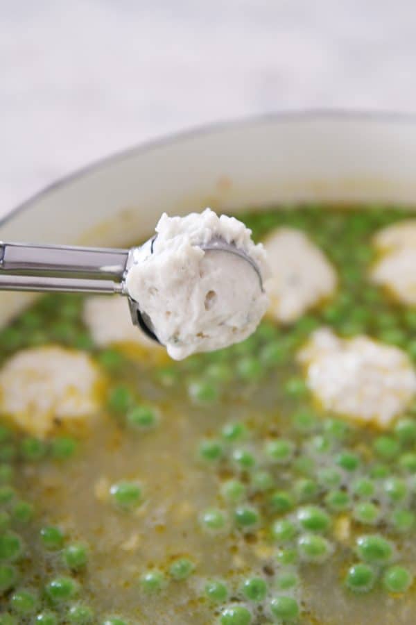 Dropping dumplings in soup with cookie scoop.