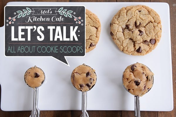 Raw cookie dough in scoops in front of baked chocolate chip cookies of varying sizes.