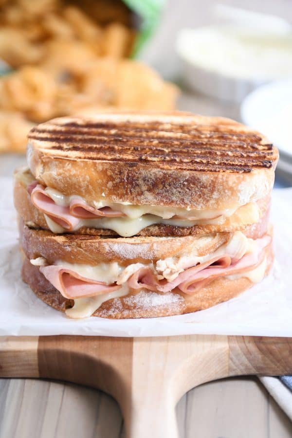 Two chicken cordon bleu panini sandwiches stacked on top of each other.
