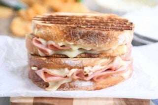 Two chicken cordon bleu panini sandwiches stacked on top of each other.