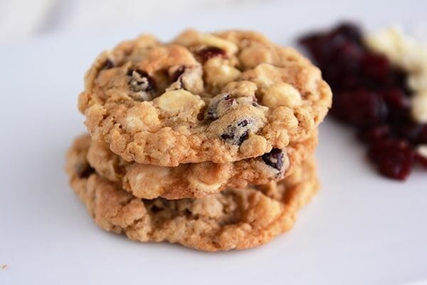 A stack of three white chocolate craisin cookies. 