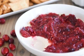 Cranberry pecan cream cheese dip in white bowl.