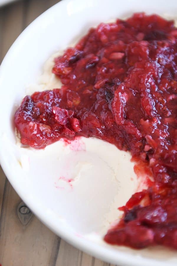 Cranberry pecan cream cheese dip in white bowl.