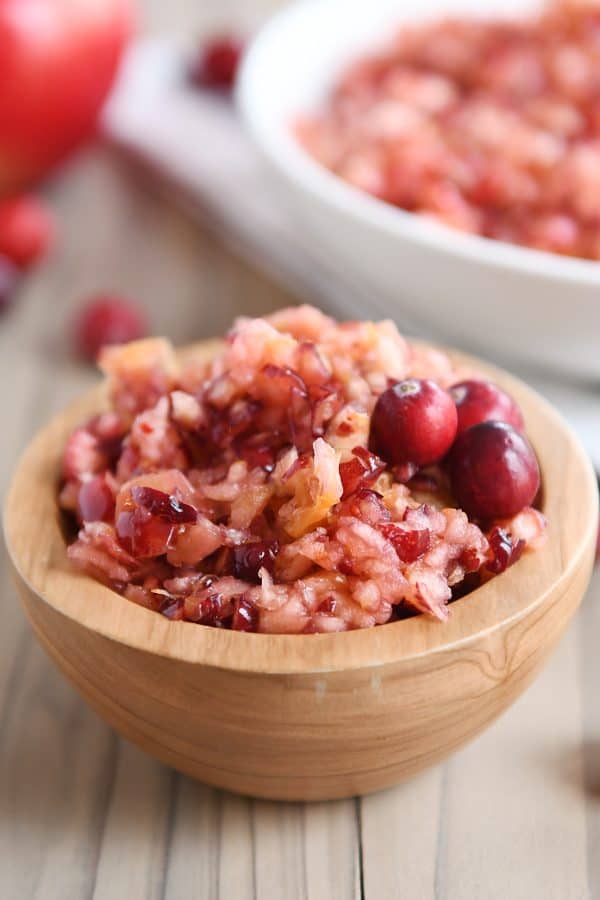 Fresh cranberry apple relish small serving in wood bowl.
