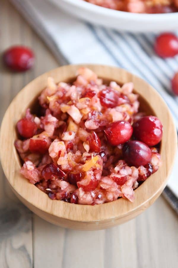 Fresh cranberry apple relish small serving in wood bowl.