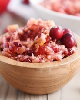 Fresh cranberry apple relish small serving in wood bowl.