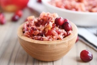 Fresh cranberry apple relish small serving in wood bowl.