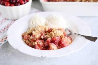 Bowl of cranberry pear crumble with vanilla ice cream.