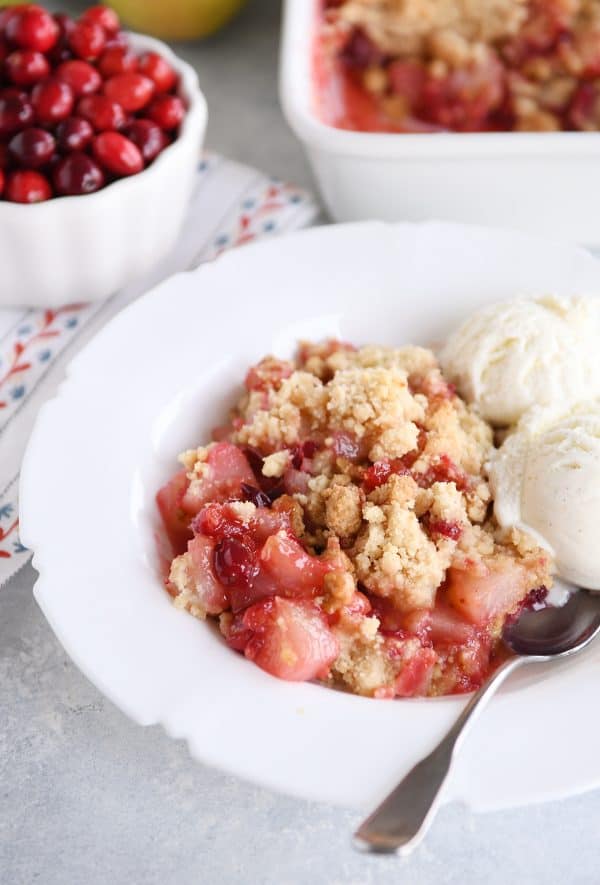 Bowl of cranberry pear crumble with vanilla ice cream.