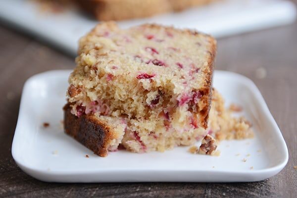 Slices of cranberry quick bread on a white plate. 