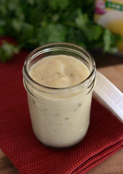 A glass mason jar full of homemade cream of chicken soup. 