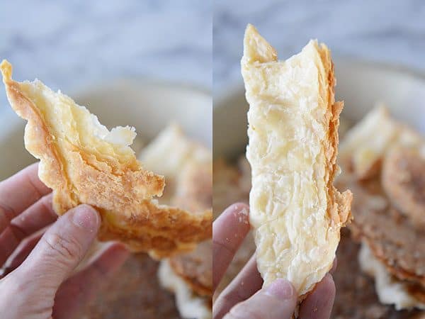 A hand holding part of a cooked pie crust.