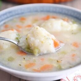 Blue bowl with chicken dumpling soup.