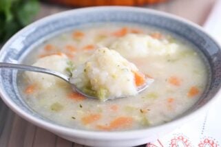 Blue bowl with chicken dumpling soup.