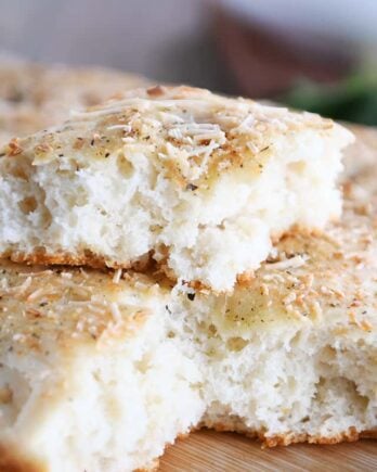 Easy focaccia bread with piece on top of loaf.