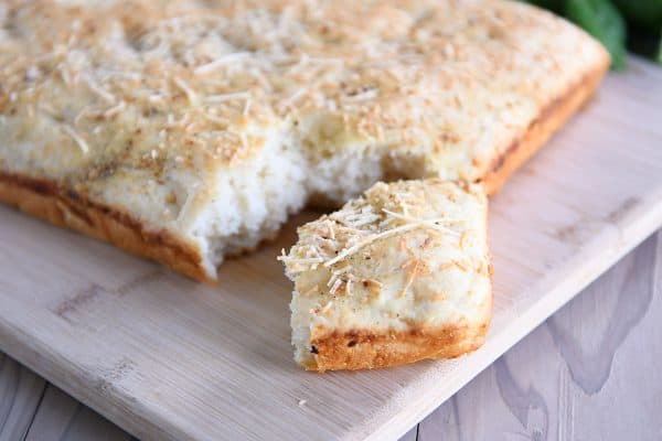 Easy focaccia bread with piece pulled apart from loaf.