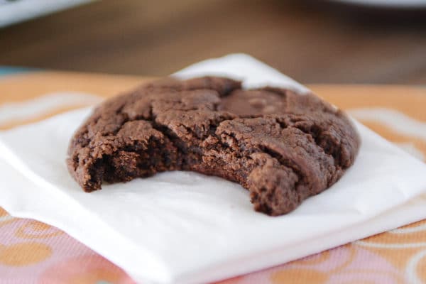 A chocolate cookie with a bite taken out. 