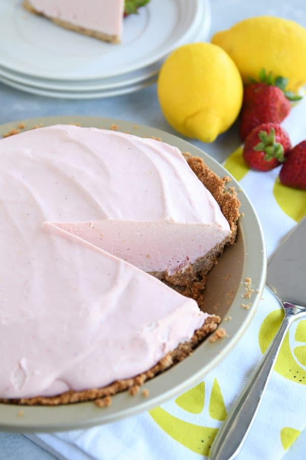 Strawberry lemonade pie with slice taken out.