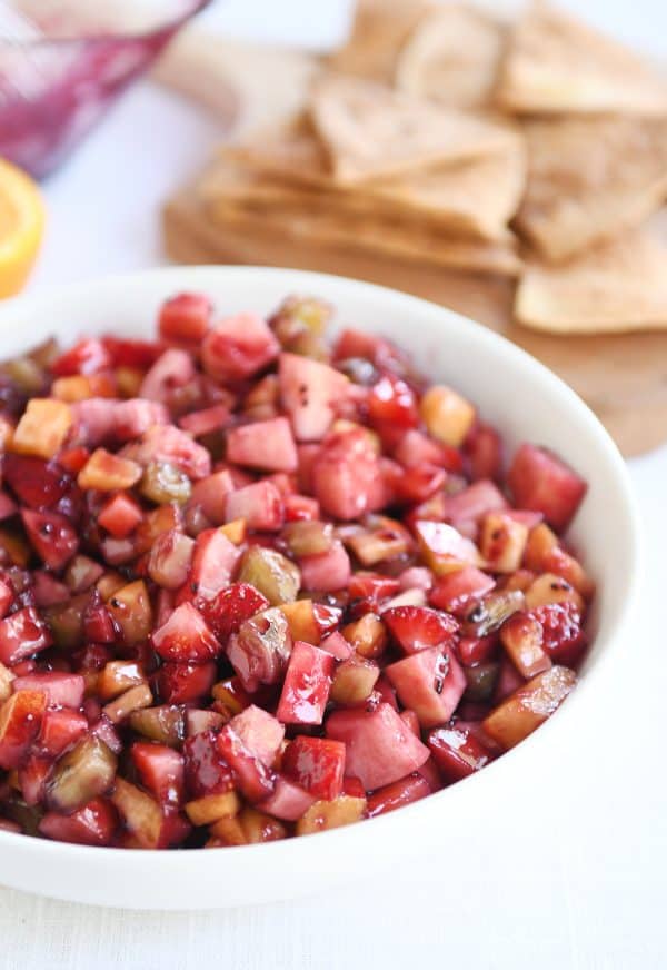 White shallow bowl with mixed fruit salsa.