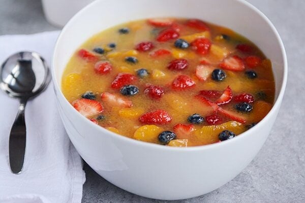 A white bowl full of berry soup.