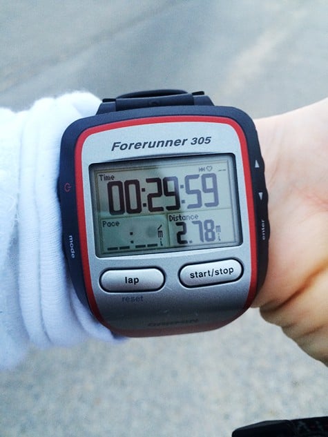 A running watch showing 29:59 on it. 