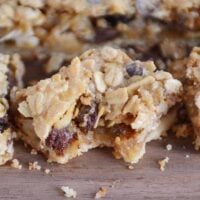 Bite taken out of caramel oat chocolate chunk shortbread bar.