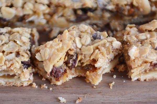 Bite taken out of caramel oat chocolate chunk shortbread bar.