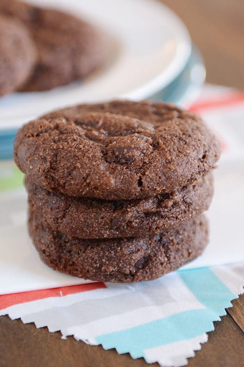 A stack of chocolate greek yogurt cookies on a colorful napkin. 