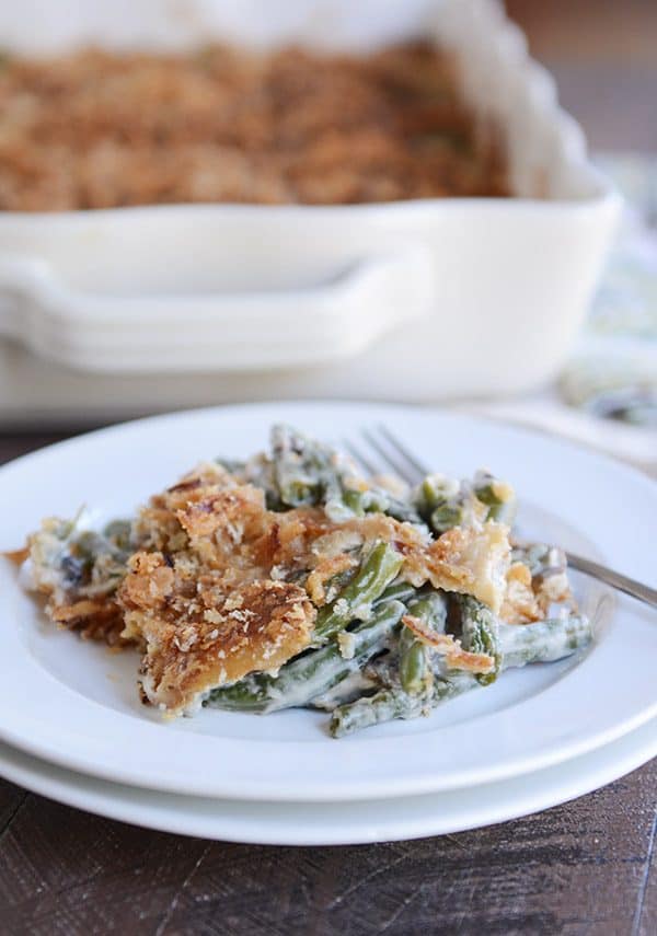 Green bean casserole with crunchy topping on a white plate.