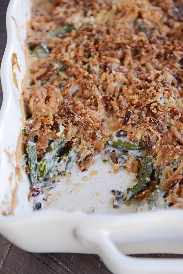 Top view of a white casserole dish full of green bean casserole topped with crunchy topping.
