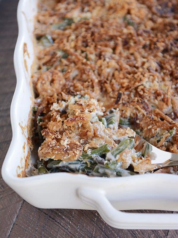 Top view of a white casserole dish of crunchy-topped homemade green bean casserole.