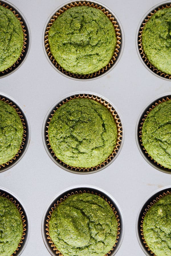 Top view of cooked green muffins in a muffin tin.